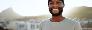 Smiling black man outdoors in beanie cap