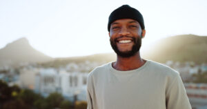 Smiling black man outdoors in beanie cap